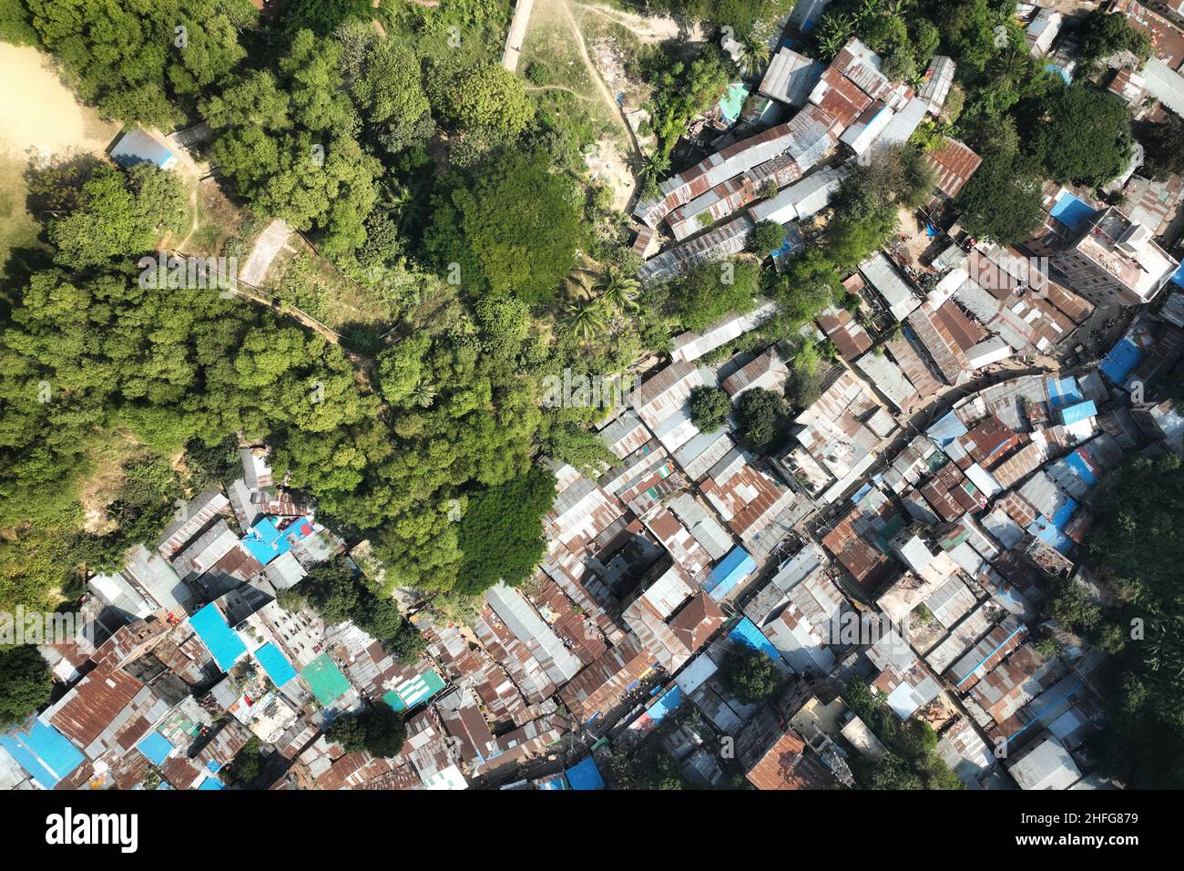 (EDITORS NOTE: image taken with a drone) An unplanned slum is upraising by cutting hill illegally in the Chittagong, the second largest city of Bangladesh. Hill cutting is continuing unabated in the city at a time when the coronavirus pandemic should be seen as a wake-up call to rethink our relationship with natural ecosystems and shrinking biodiversity. In 2015 International journal of nature and life sciences published a research report where wrote that, In the past 28 years, maximum 64% hill was totally demolished in the metropolitan area of Chittagong. On June 11, 2007, as many as 127 peop Stock Photo