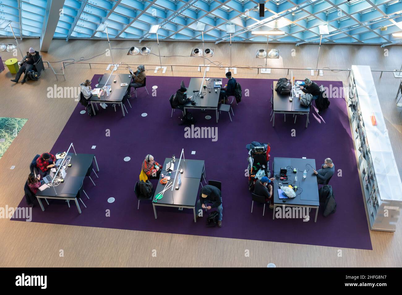 Visitors use the facilities in the main level “Living Room” of the Seattle Central Library in downtown Seattle. Stock Photo