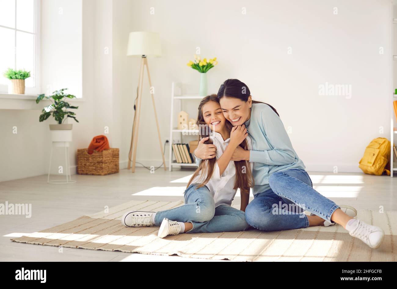 Smiling mother and small daughter have fun at home Stock Photo