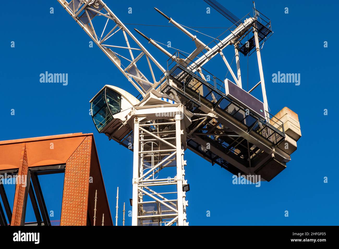 Architect plan on working table with crane and building construction background Stock Photo