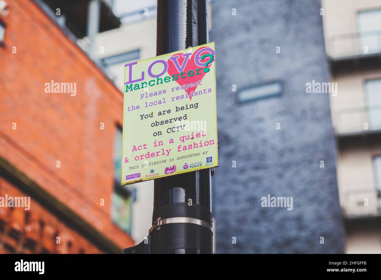 A street sign in Manchesters Northern Quarter promoting respect for the local neighbourhood displaying CCTV observance Stock Photo