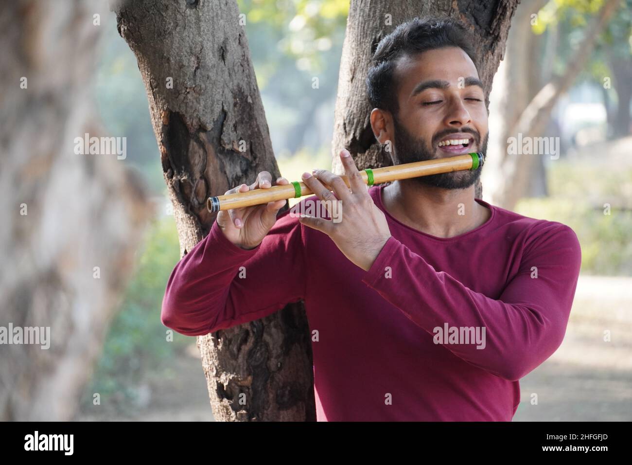 A man is playing the musical instrument { flute} Stock Photo