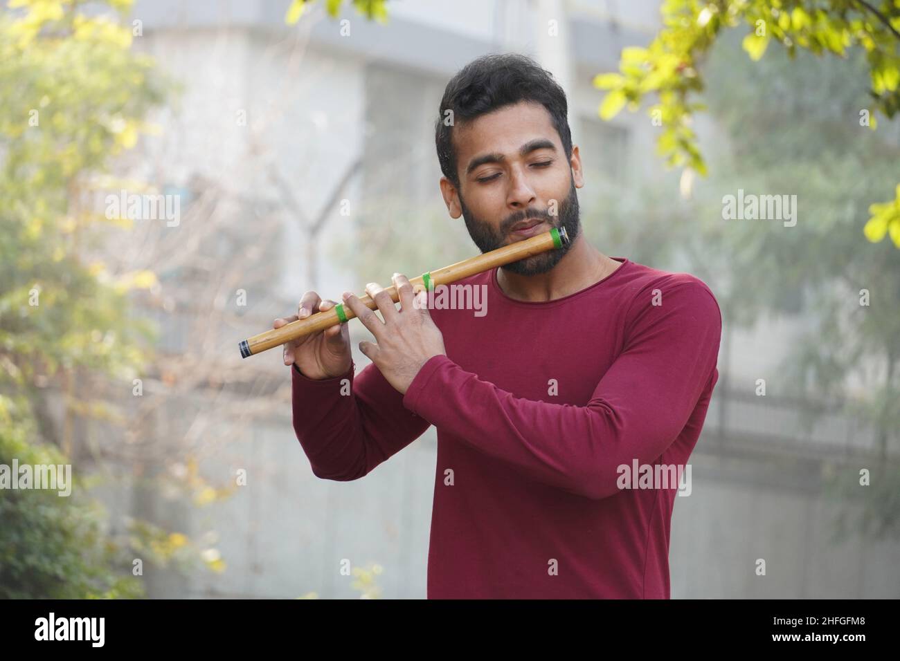 Man Playing Flute - Indian Musical Instrument Stock Photo