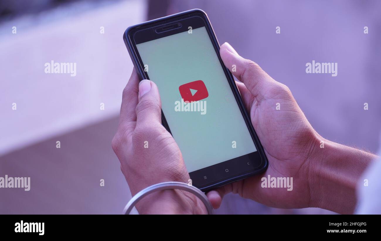 youtube splash screen logo in in mobile and mobile in hand Stock Photo Alamy