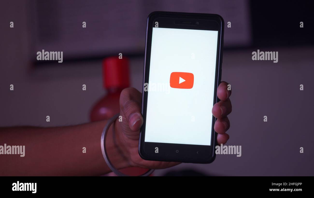 youtube splash screen logo in in mobile and mobile in hand Stock Photo Alamy