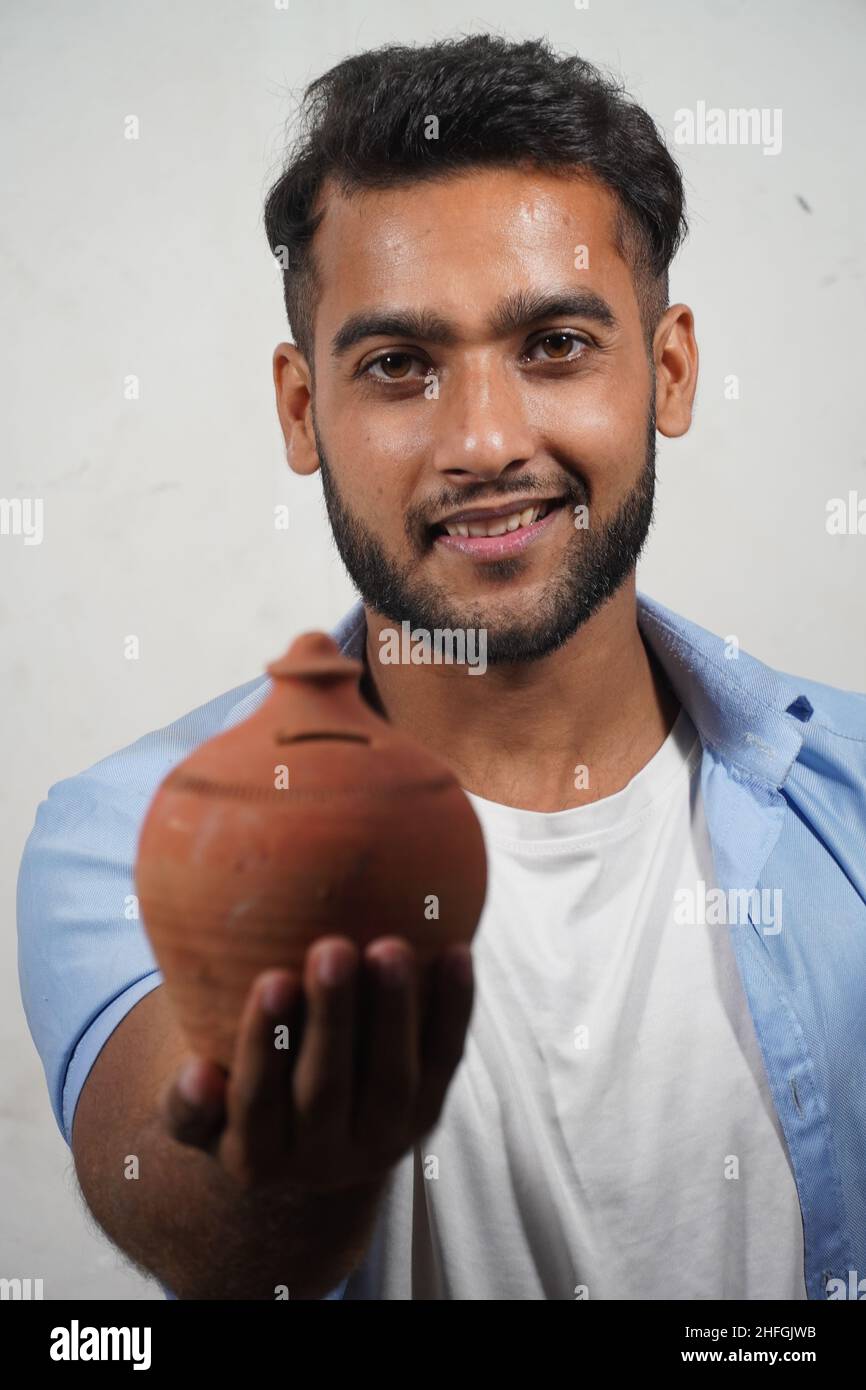 Indian Man Showing His Indian Piggy Bank Stock Photo Alamy