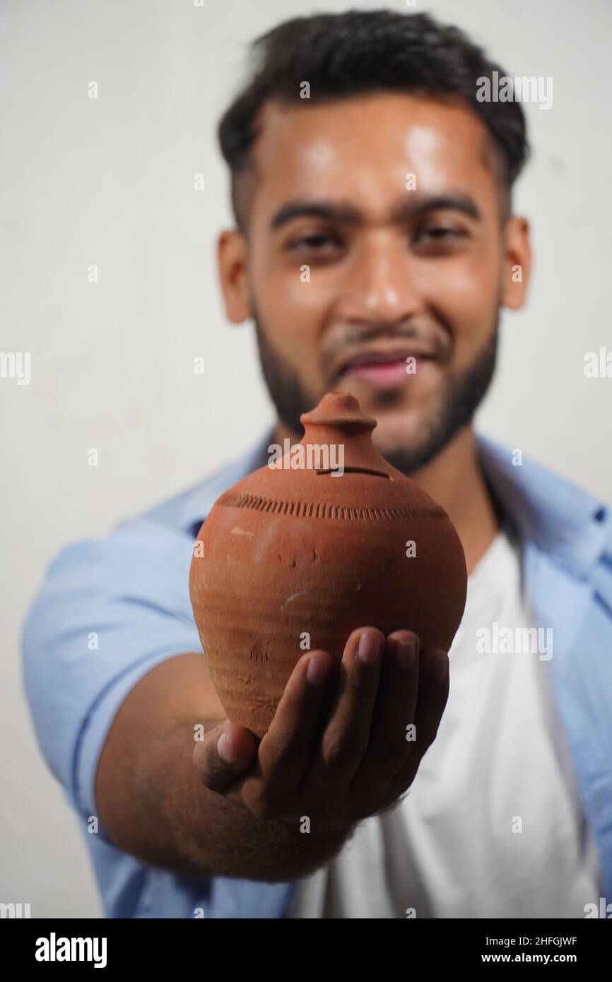 A boy Showing his piggy bank indian piggy bank selective focus image