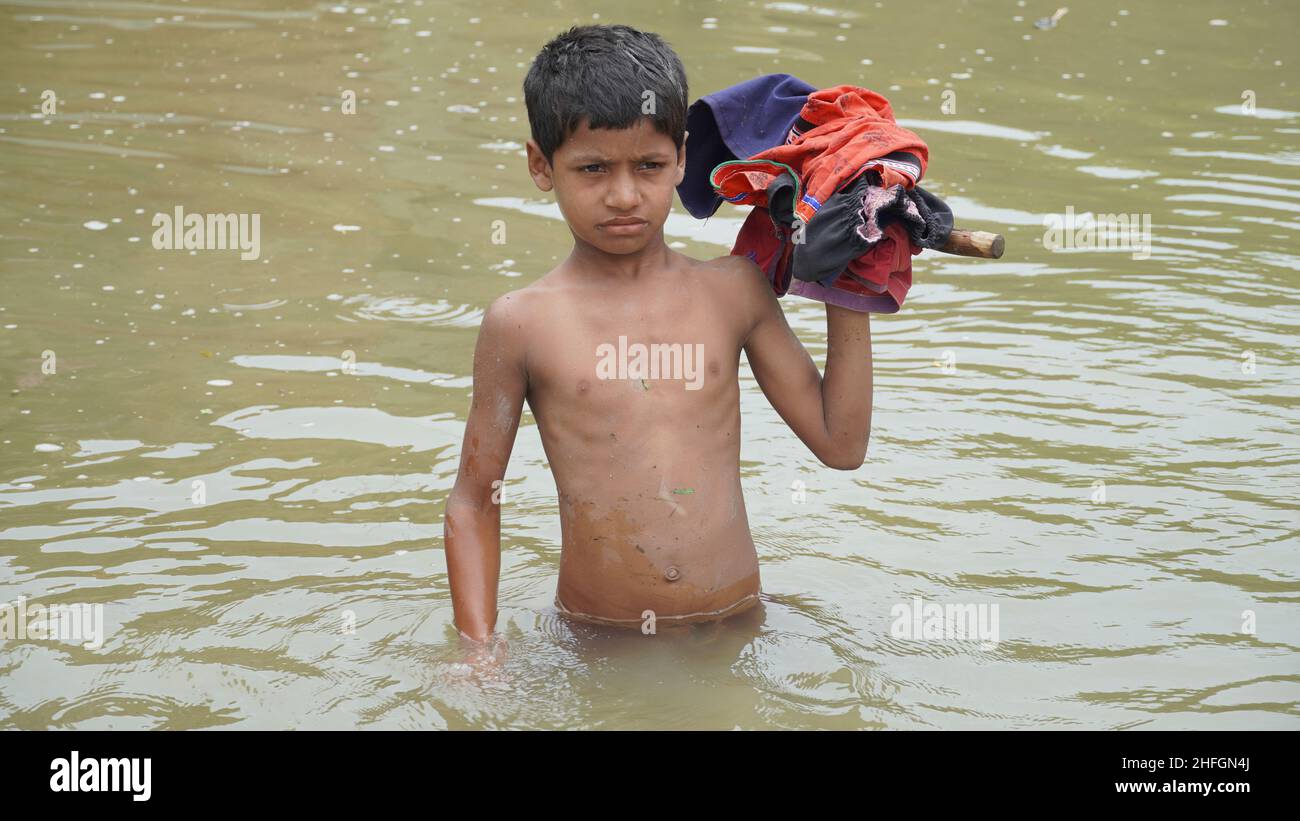 poor kid in flood -flood concept Stock Photo