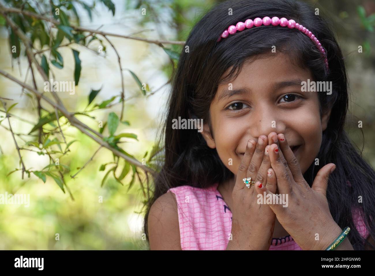 A beautiful Girl Watching in camera and smiling - Girl Education Concept Stock Photo