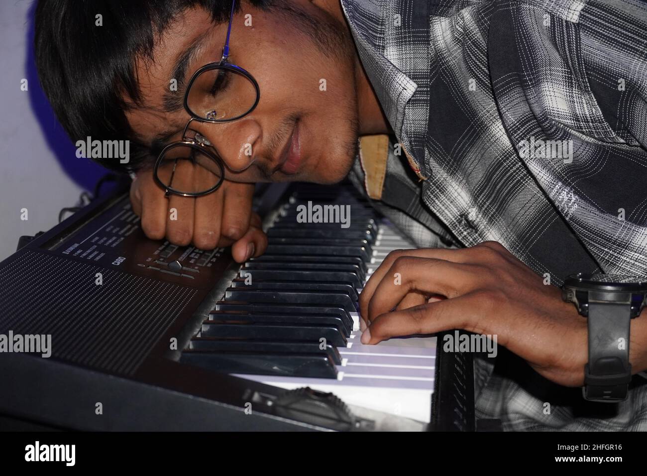 A boy is fallen in love with piano Stock Photo