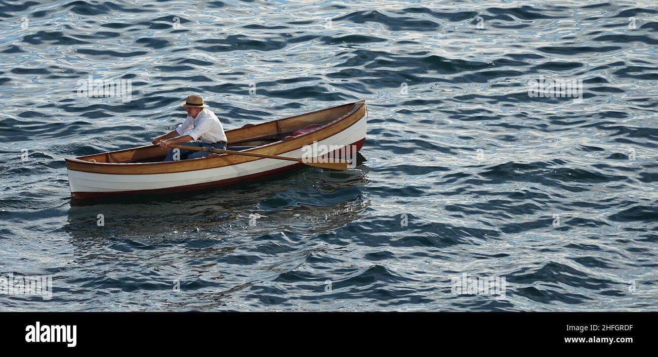 Man Rowing a Canoe in Alaska Waters Stock Photo
