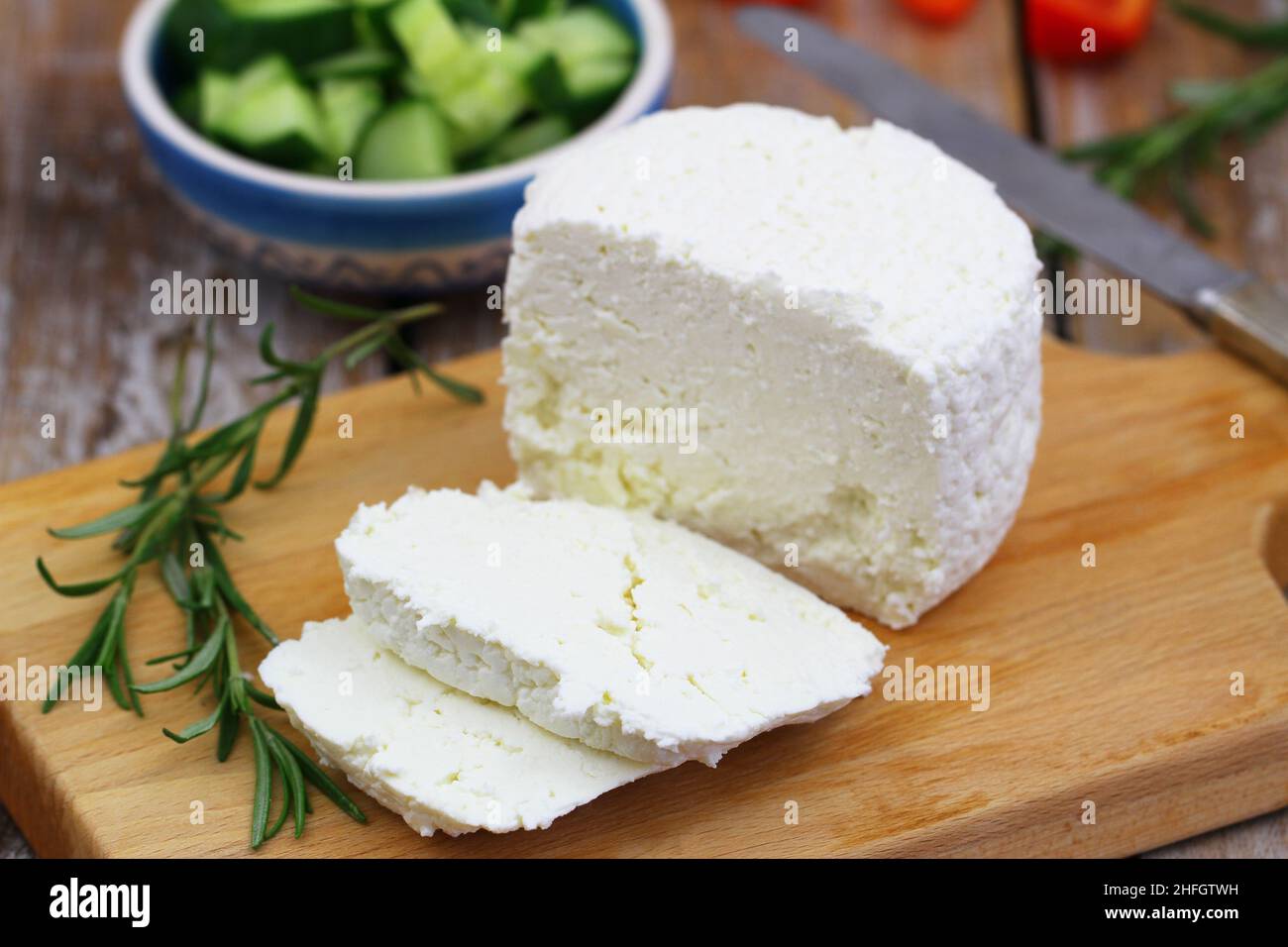 Slices of curd cheese, traditional Polish dairy product on wooden board Stock Photo
