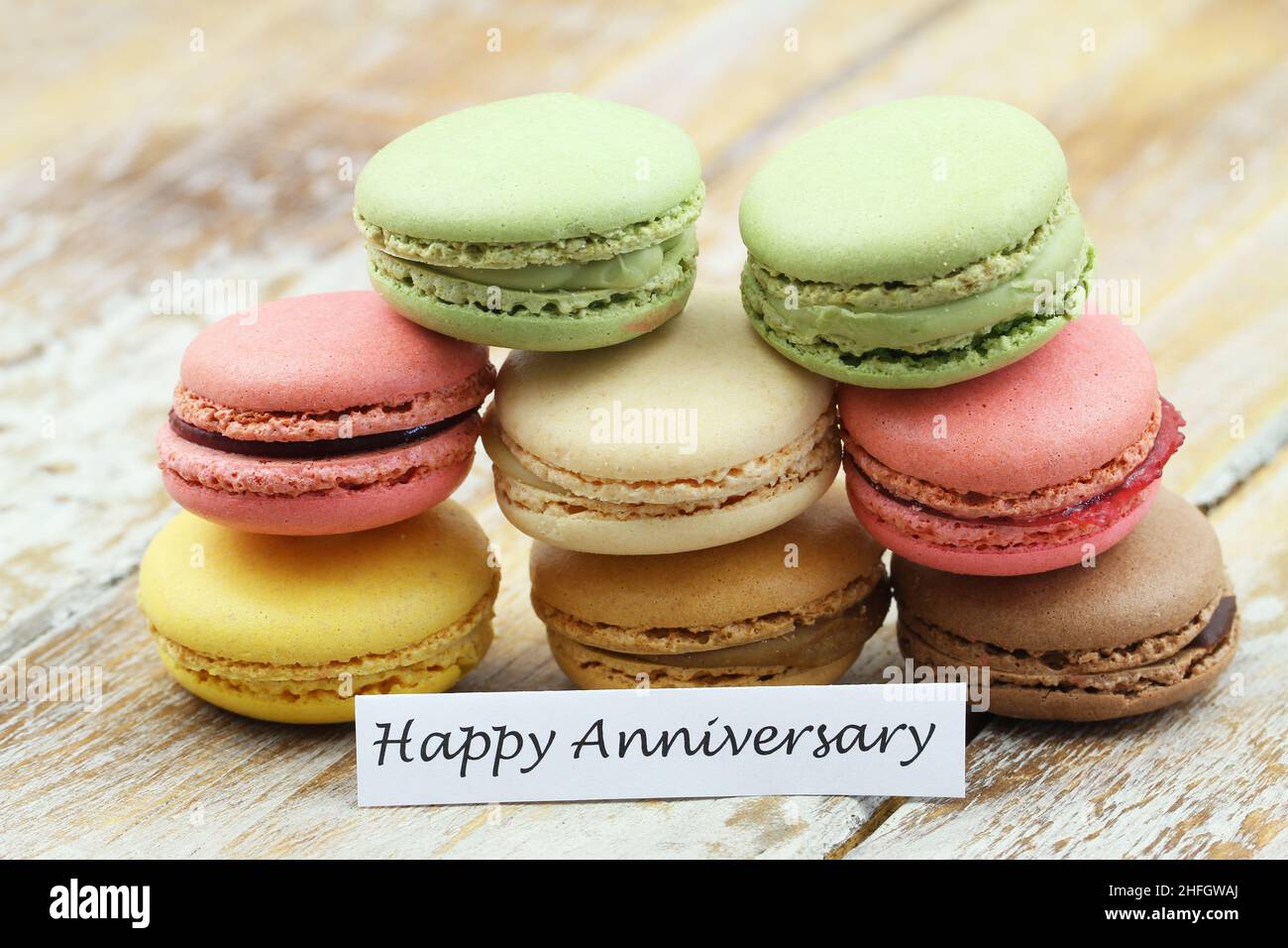 Happy anniversary card with a stack of colorful, crunchy, sweet macaroons Stock Photo