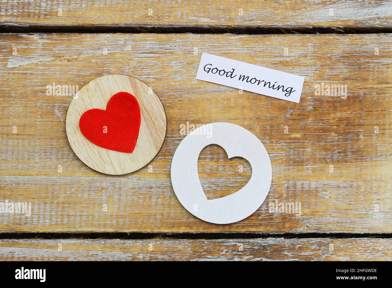 Good morning card with two wooden hearts on rustic surface Stock Photo