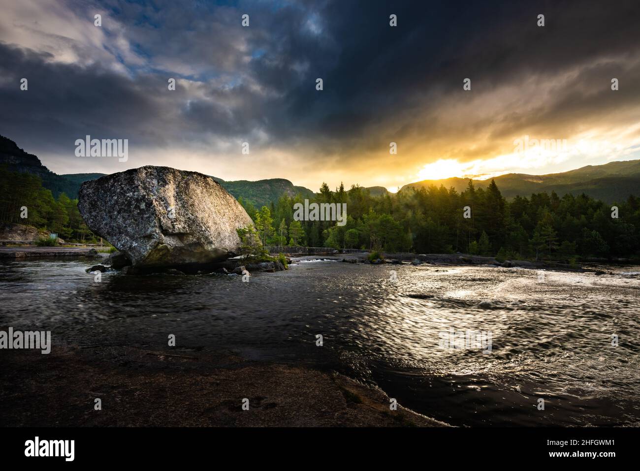 Honnevje rest stop by Otra river at sunrise, Sorlandet and Telemark Norway- Beautiful Giant boulder lit by morning sunlight. Stock Photo