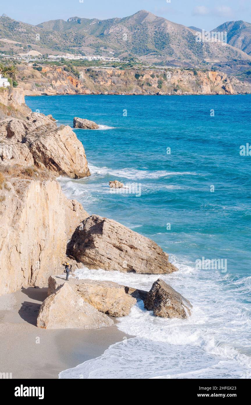 Aerial top view of sea waves hitting rocks on the beach with turquoise ...