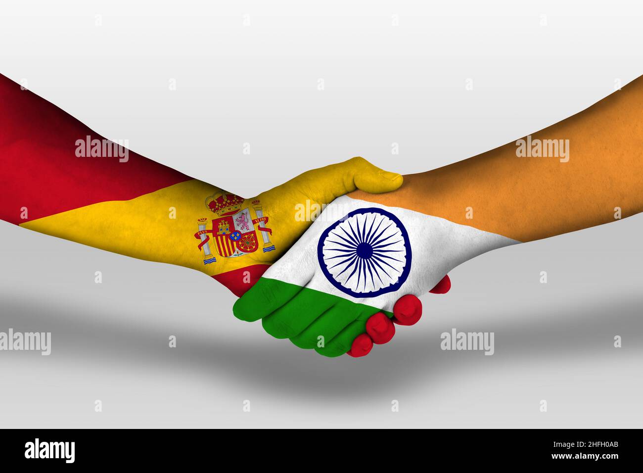 Handshake between hong kong and spain flags painted on hands