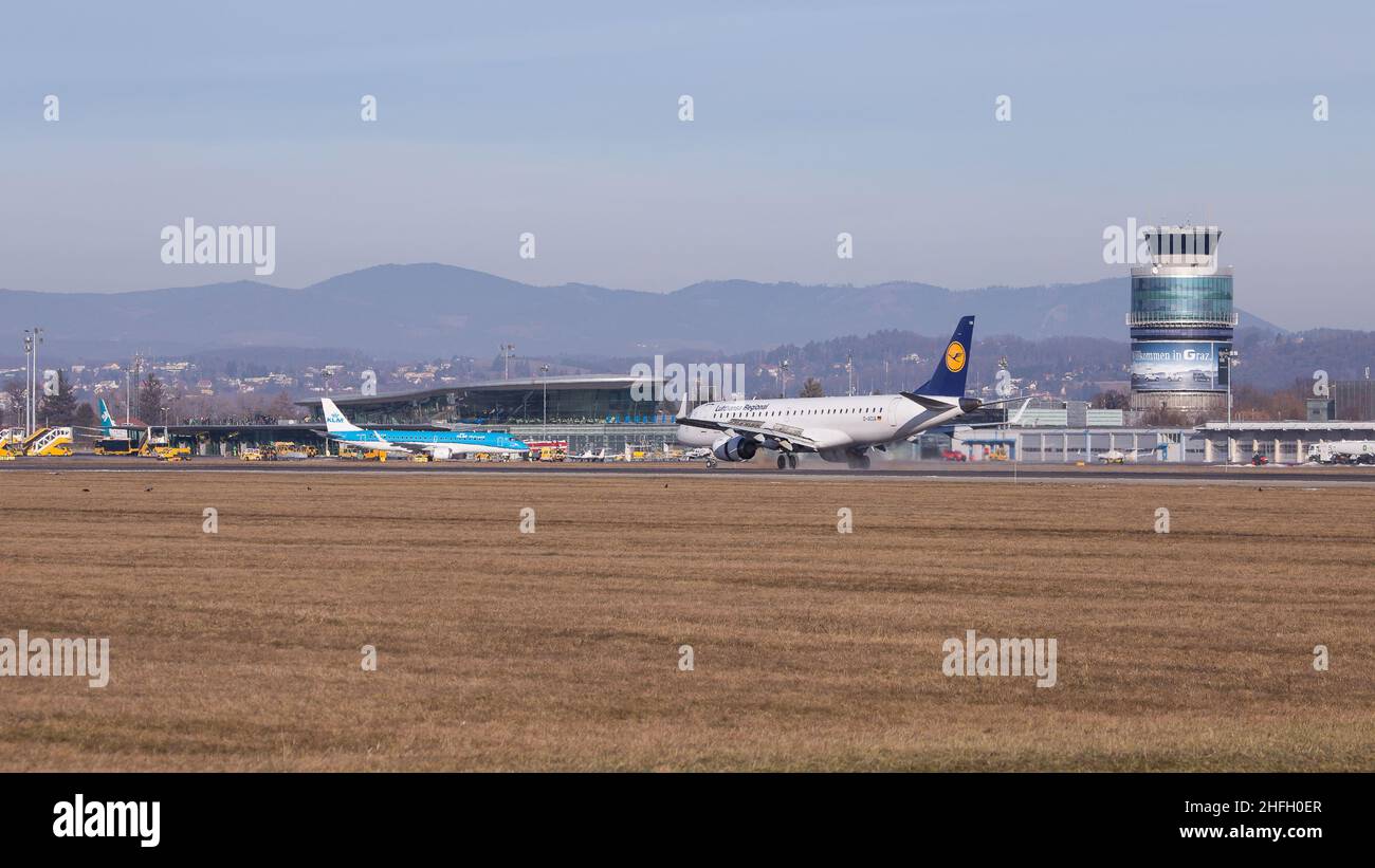 Panorama view of aerodrome Graz in Austria with terminal and tower with airplanes on the runway and apron Stock Photo