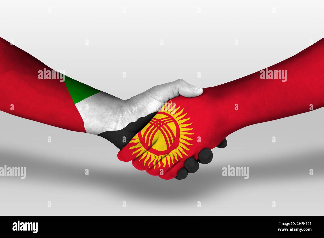 Handshake between kyrgyzstan and united arab emirates flags painted on hands, illustration with clipping path. Stock Photo