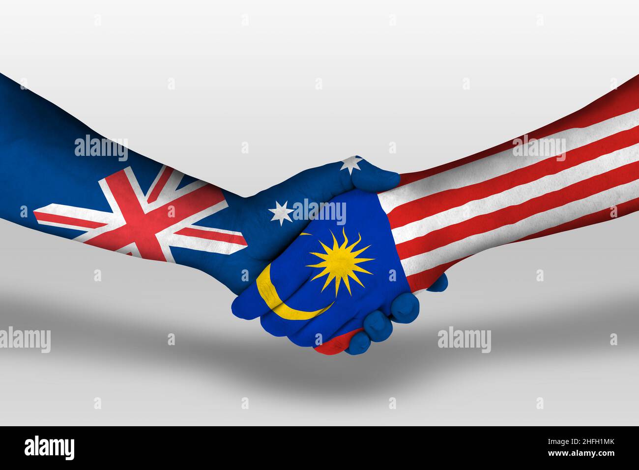 Handshake between malaysia and australia flags painted on hands, illustration with clipping path