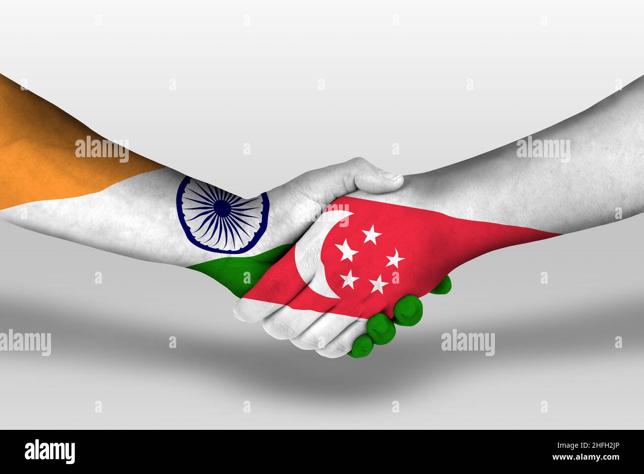 Handshake between singapore and india flags painted on hands