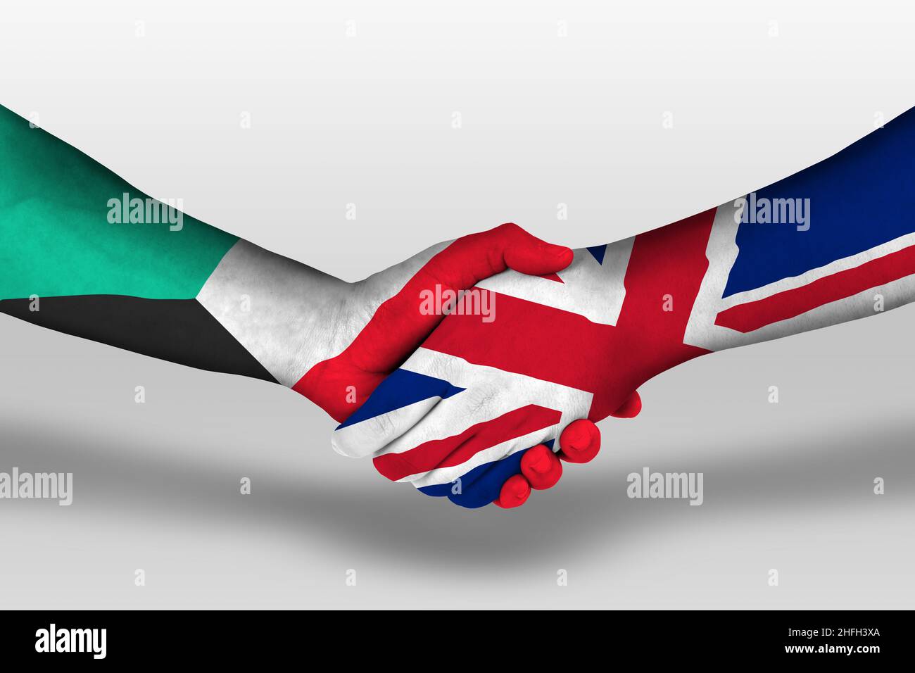 Handshake between united kingdom and kuwait flags painted on hands, illustration with clipping path. Stock Photo