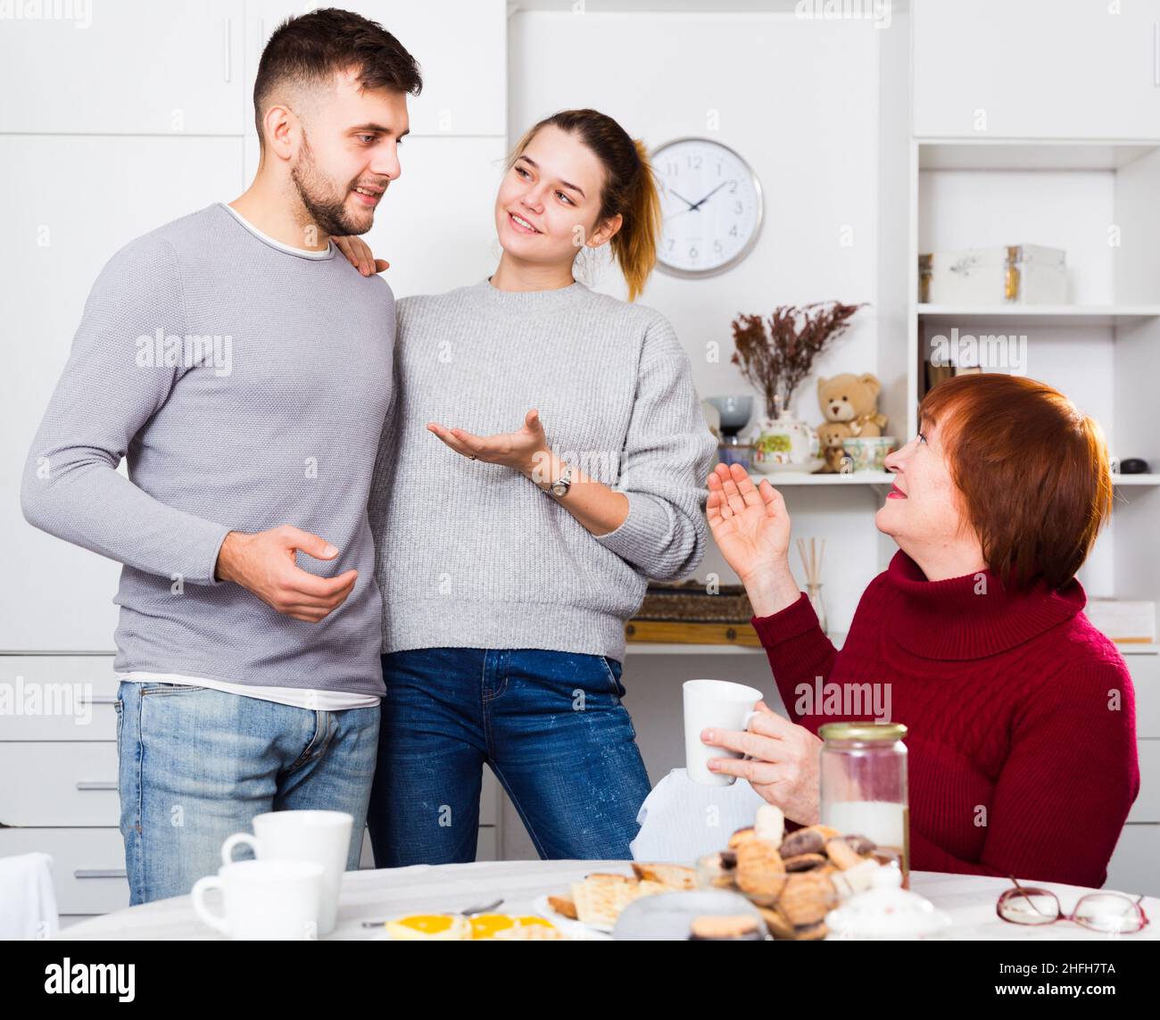 Happy girl introducing boyfriend to mother Stock Photo