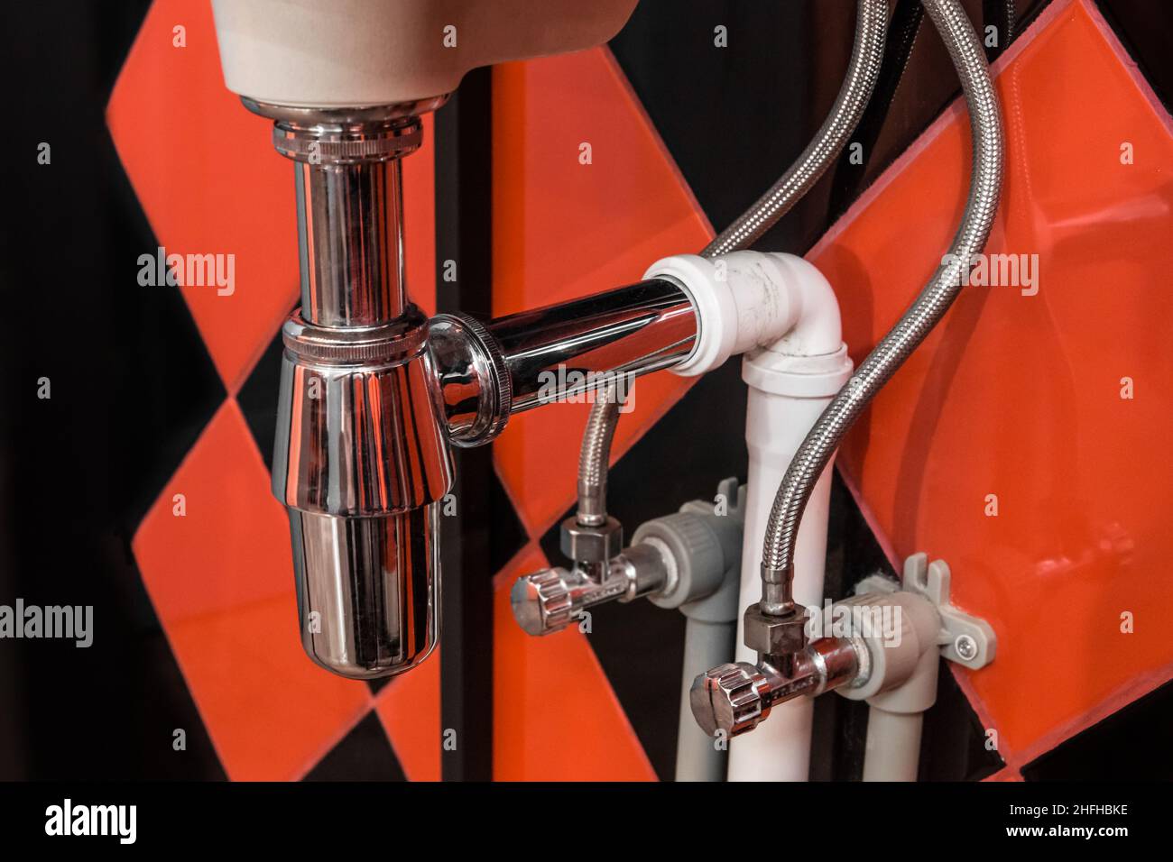 Plumbing tube pipe under sink steel water pipe system Stock Photo Alamy
