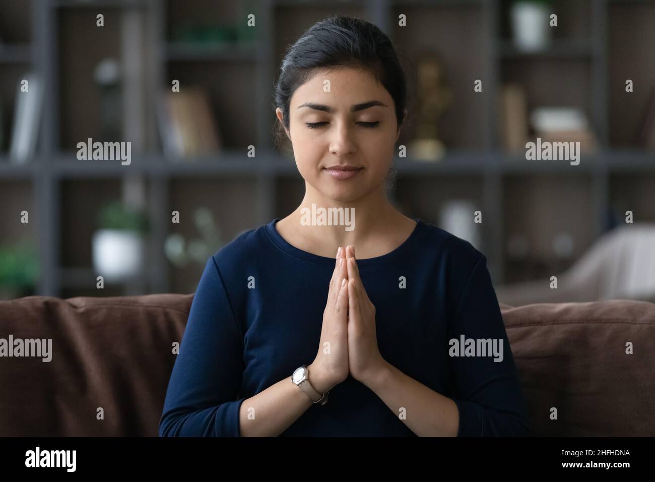 Happy beautiful young Indian woman praying God. Stock Photo