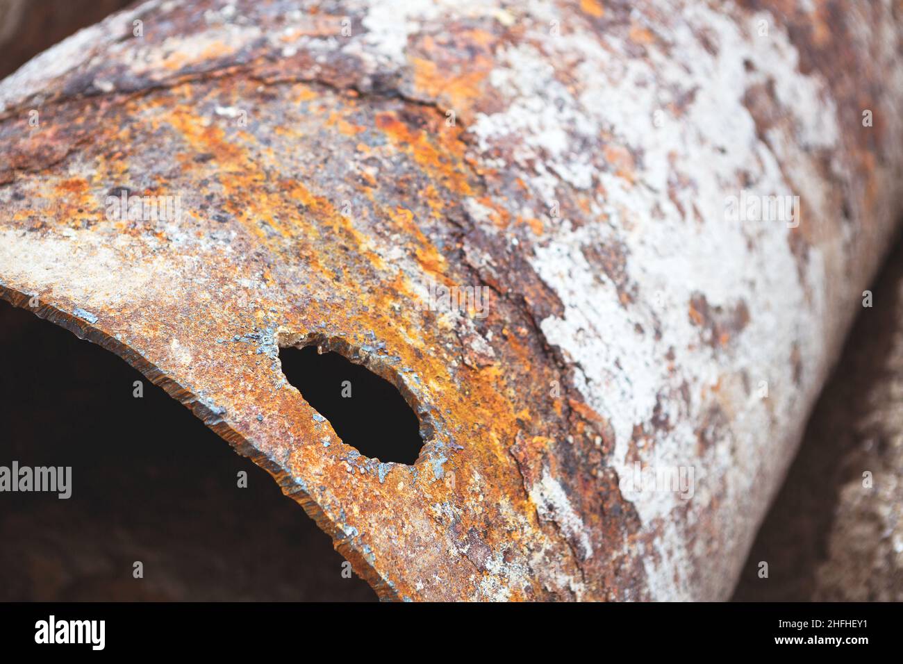 Fragments of old large water pipes. After many years of operation, corroded metal pipe destroyed. Rusty steel tube with holes metal corrosion. Selecti Stock Photo
