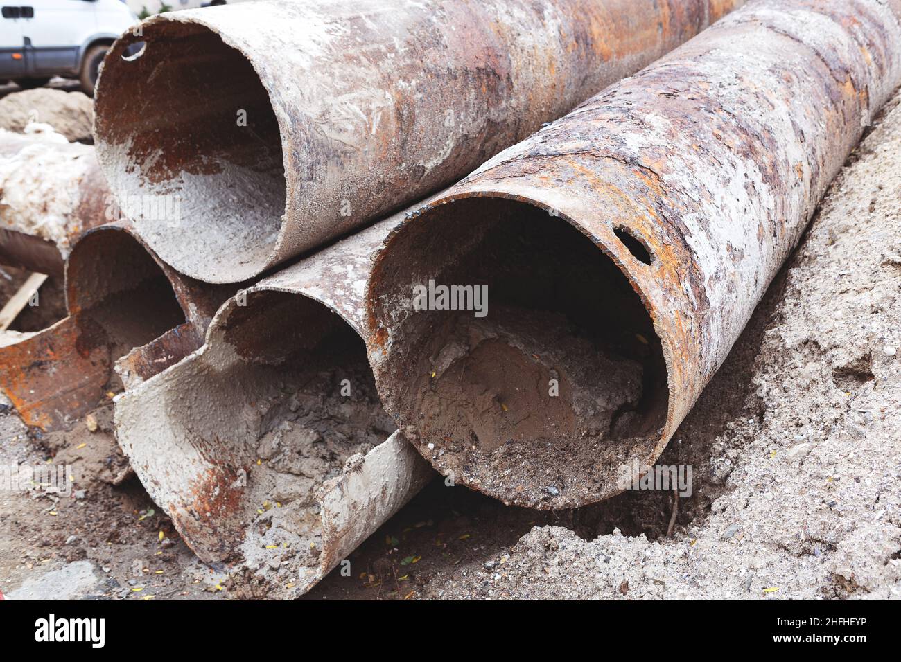 Fragments of old large water pipes. After many years of operation, corroded metal pipe destroyed