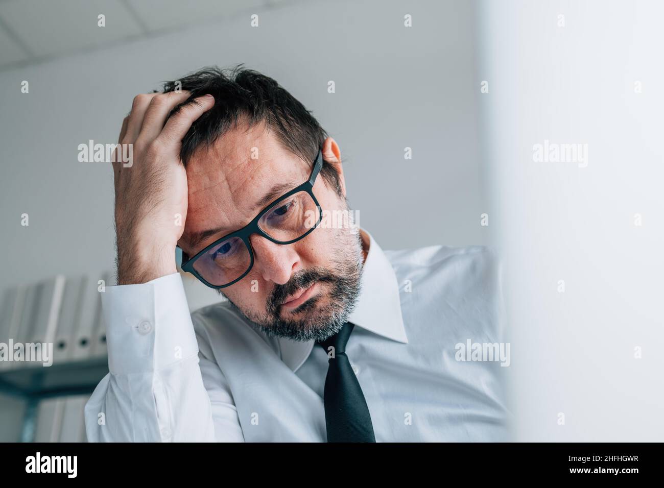 Regretting bad business decision, disappointed businessman in office, selective focus Stock Photo