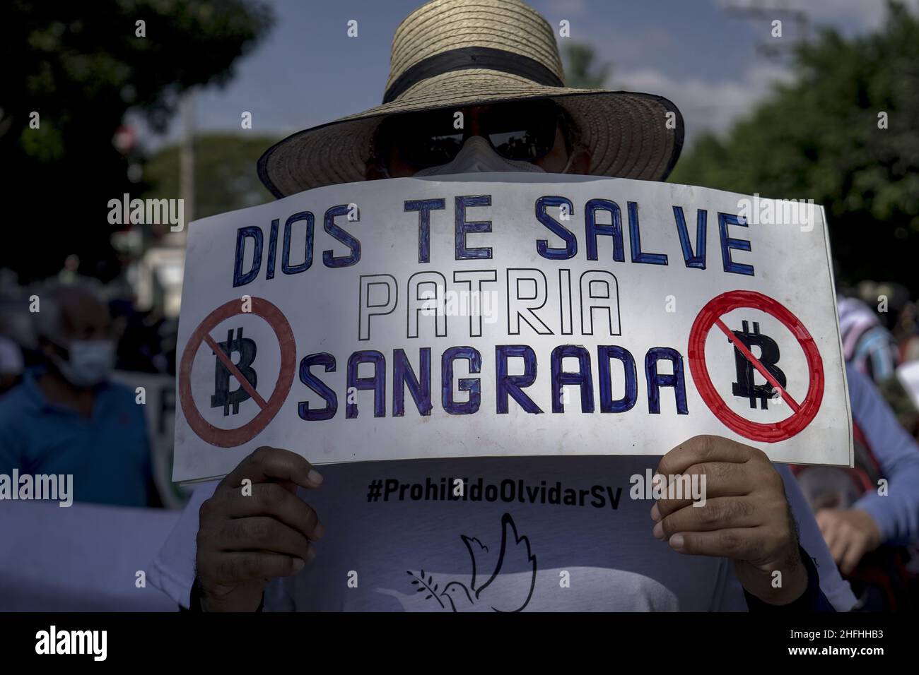 A man holds a sign against the Bitcoin law that says 'God bless you holly nation' during a march of war veterans and social movements to protest against the authoritarian policies of the Salvadoran government on the 30th anniversary of the signing of the peace accords.In 1992 El Salvador put an end to a 12 year war with a peace treaty signed in Mexico between the Salvadoran government and former guerrilla Frente Farabundo Martí para la Liberación Nacional (FMLN). President of El Salvador Nayib Bukele through his party in Congress voted a law to remove the anniversary as a national day. (Photo Stock Photo