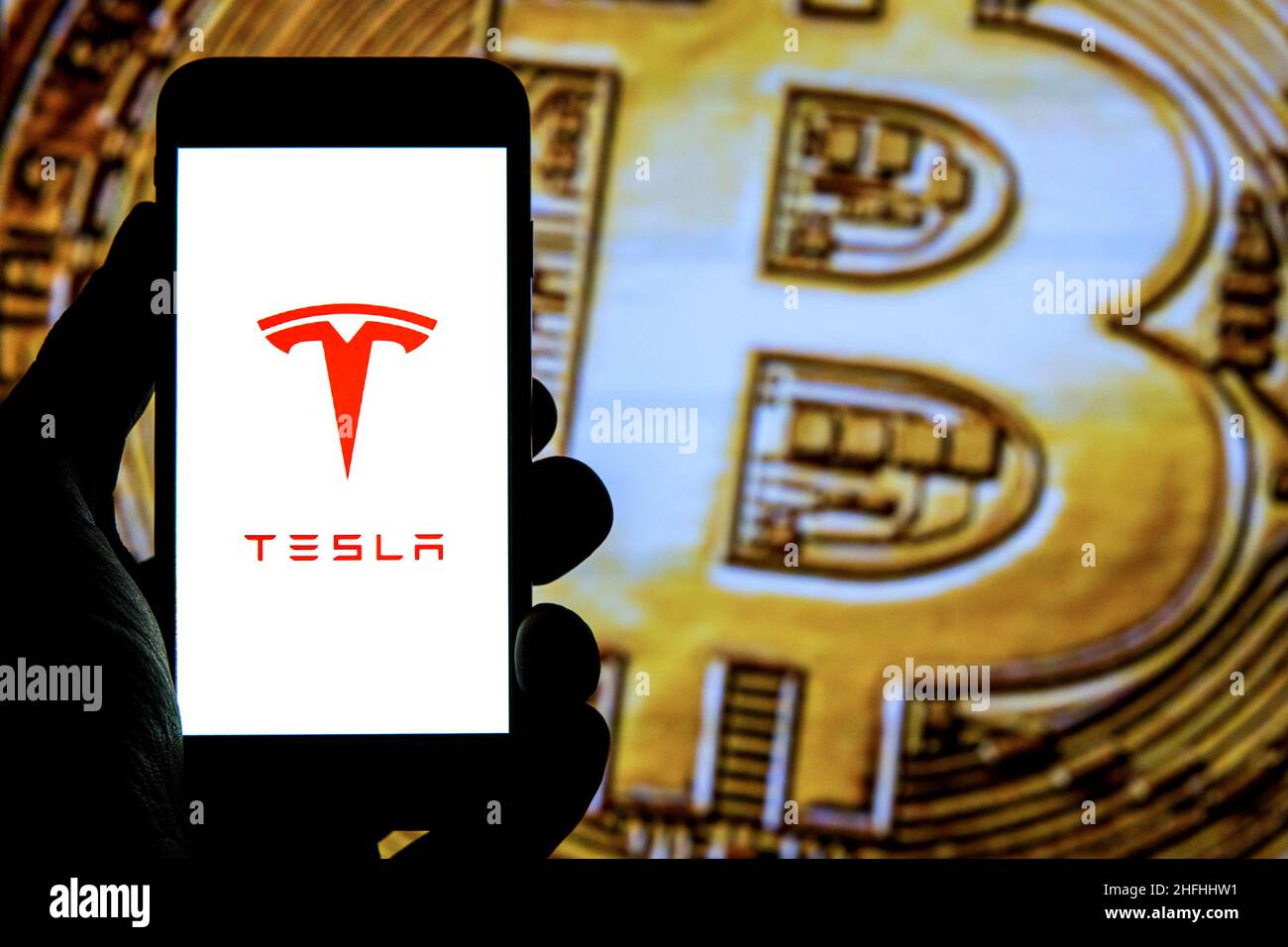 Bitcoin and Tesla logo seen on paper document. Concept for investment in  cryptocurrency. Selective focus Stock Photo - Alamy