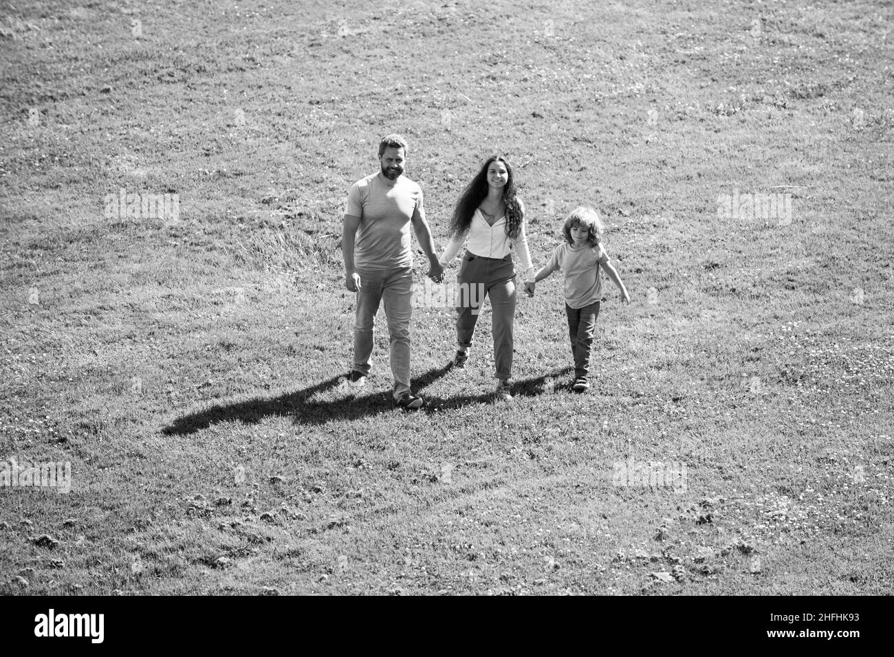 Arial view of young family with child walking and having fun in nature. Stock Photo
