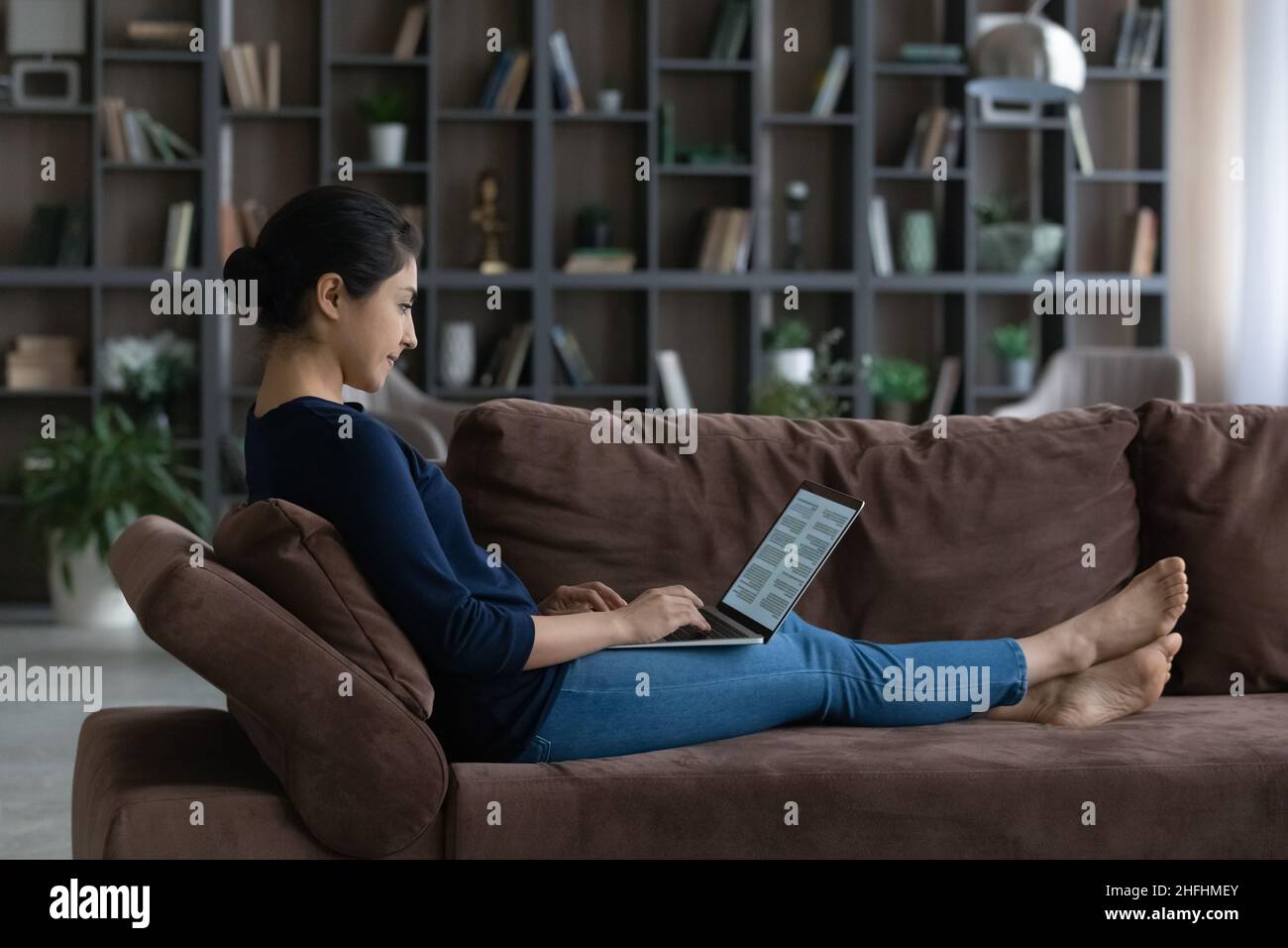 Happy young Indian woman working with document on computer Stock Photo ...