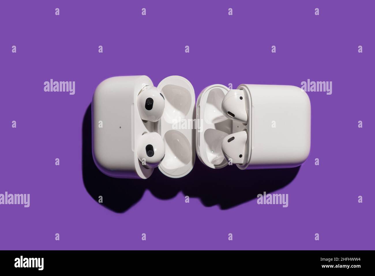 Barcelona, Spain - January 2022. Airpods pro compared with apple air pods 2  in wireless charging case on violet background. Headphones, vertical, copy  Stock Photo - Alamy