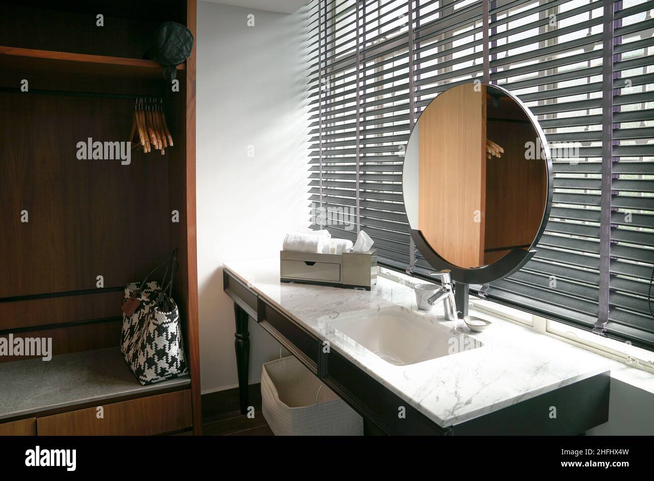 Hotel bathroom interior with sink, mirror and wardrobe cupboard. Stock Photo