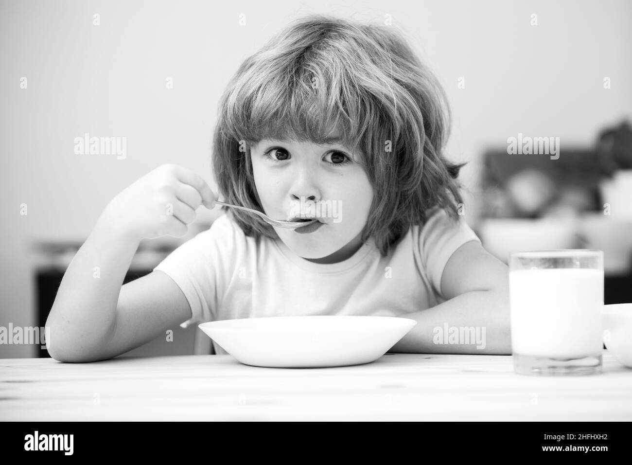 Food and drink for kids. Child eating healthy food. Cute little boy having soup for lunch. Stock Photo