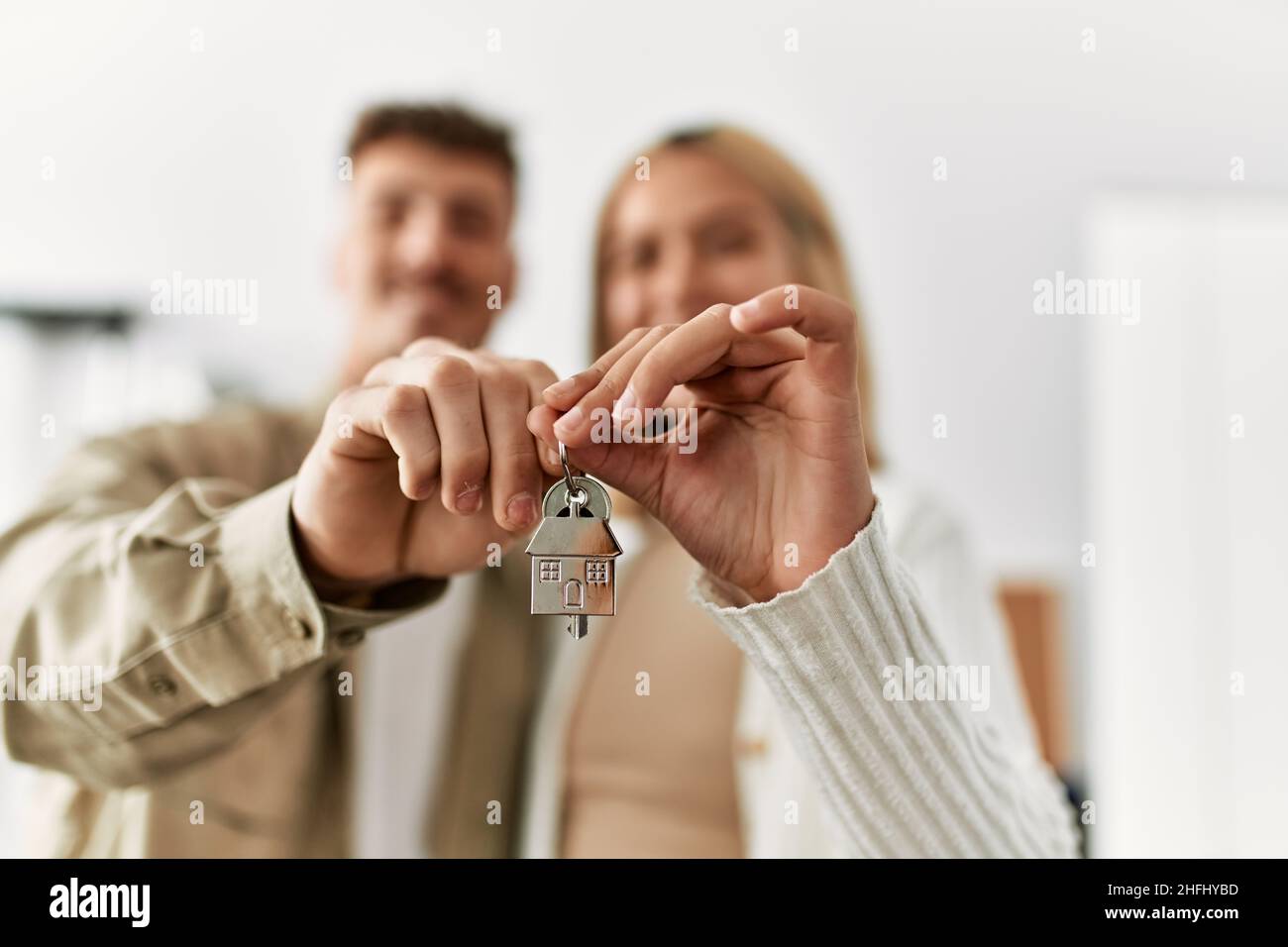 Young caucasian couple smiling happy holding key of new home Stock ...