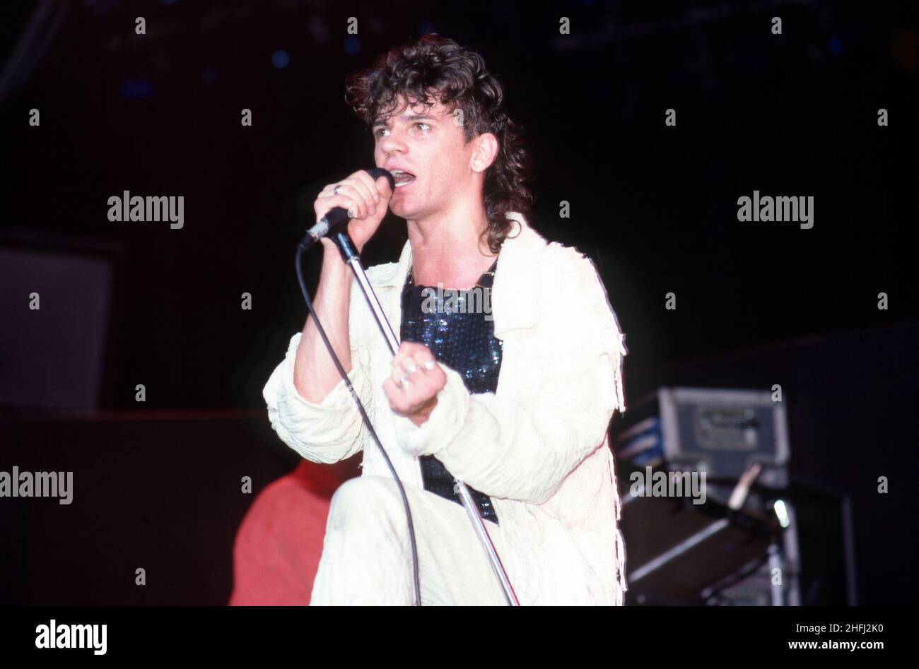 CLARKSTON, MI - JUNE 22: Lead singer Michael Hutchence (1960-1997) of the new wave group INXS sings on stage during their 1984 Swing Tour on June 22, 1984 at the Pine Knob Music Theatre in Clarkston, Michigan  Credit: Ross Marino / Rock Negatives / MediaPunch Stock Photo