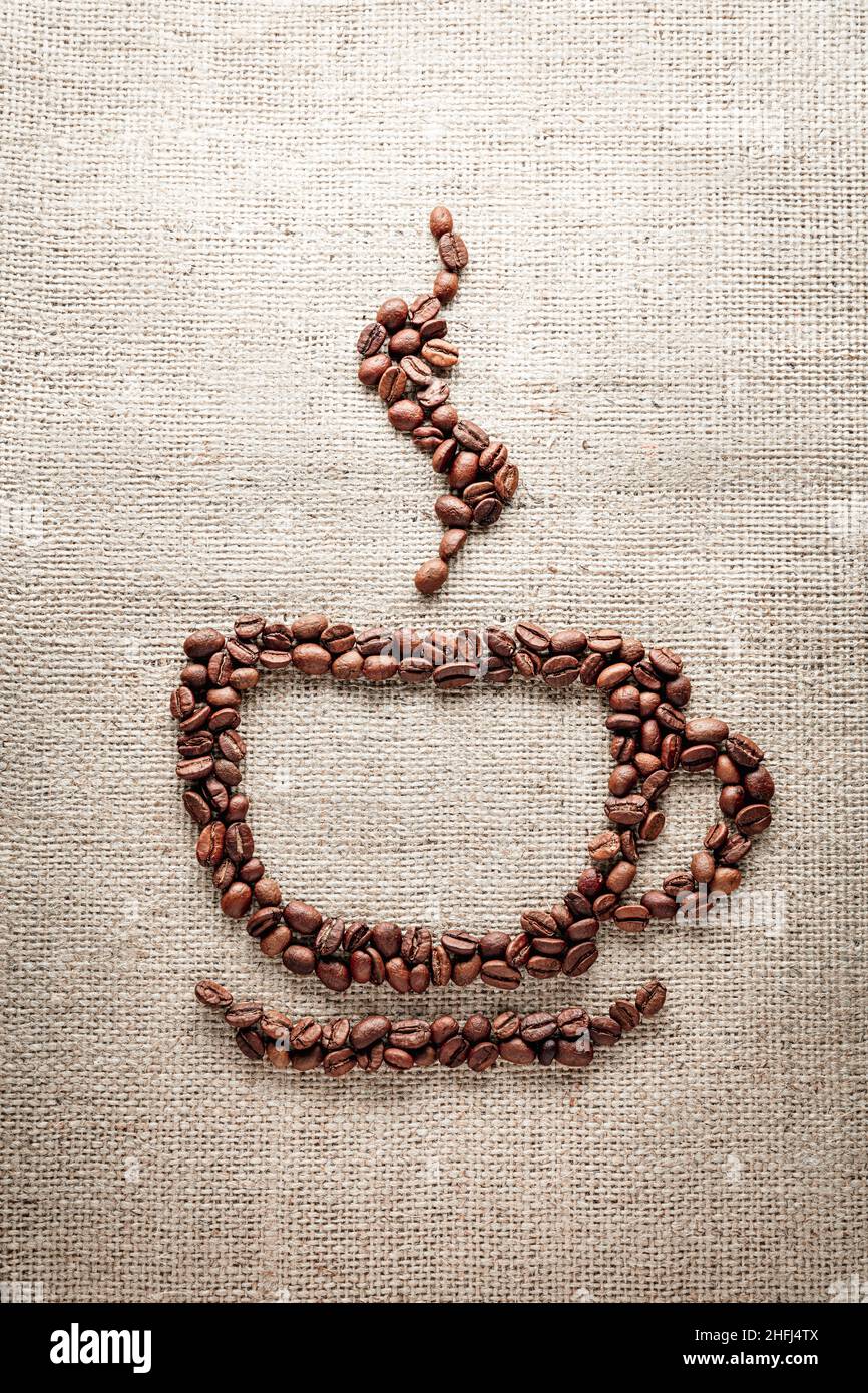 Coffee cup shape on burlap background Stock Photo