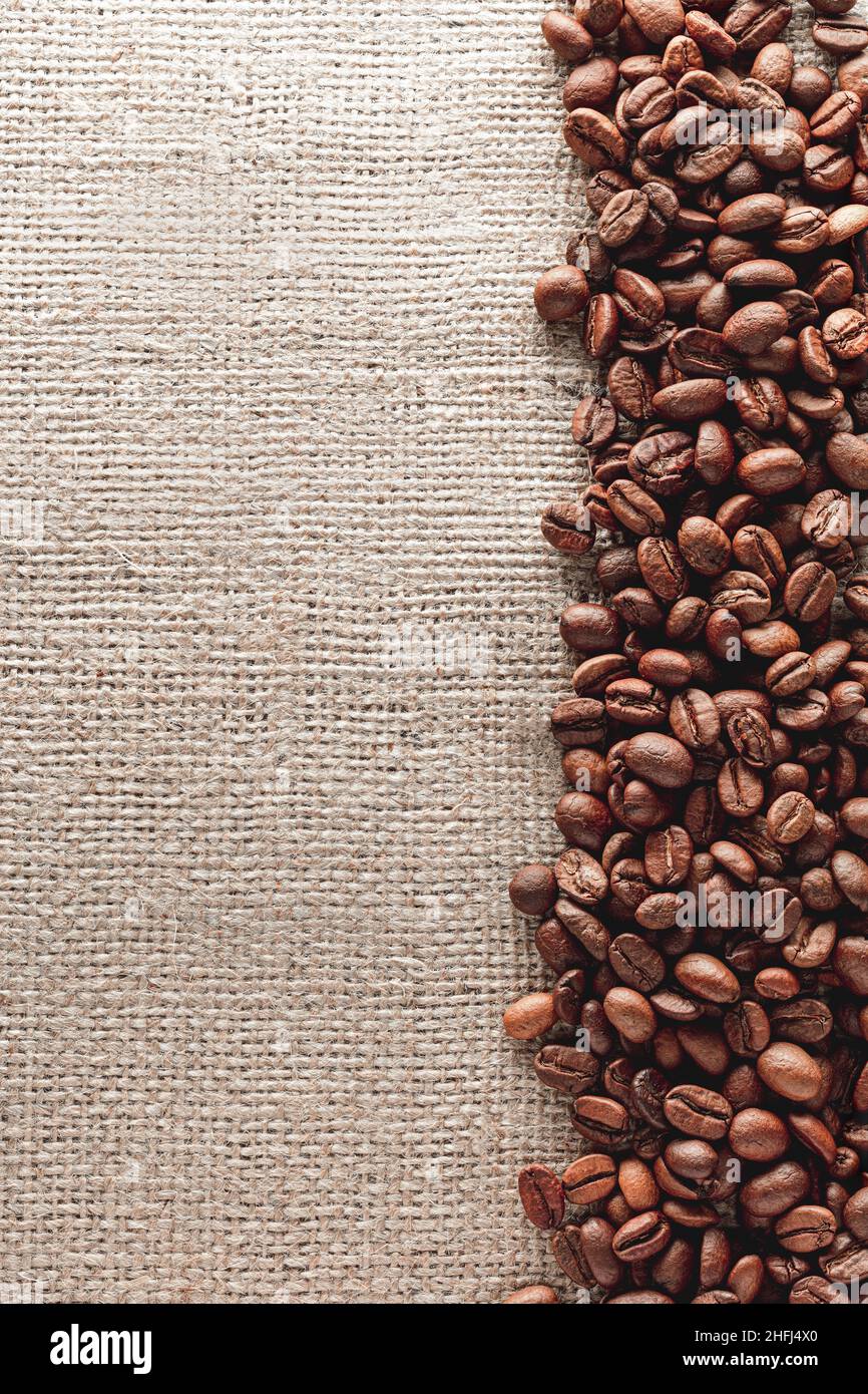 Coffee beans on burlap background Stock Photo