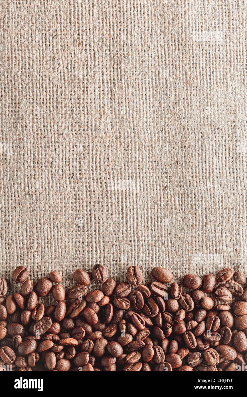 Coffee beans on burlap background Stock Photo