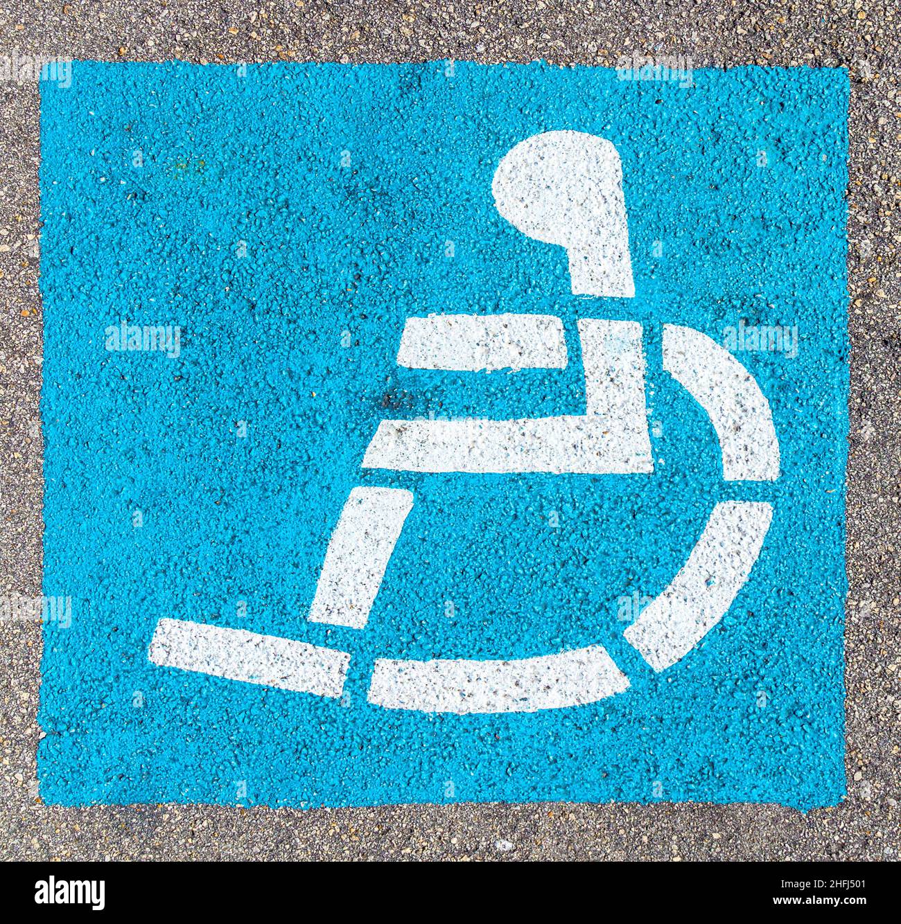 wheelchair sign at the parking lot in blue Stock Photo