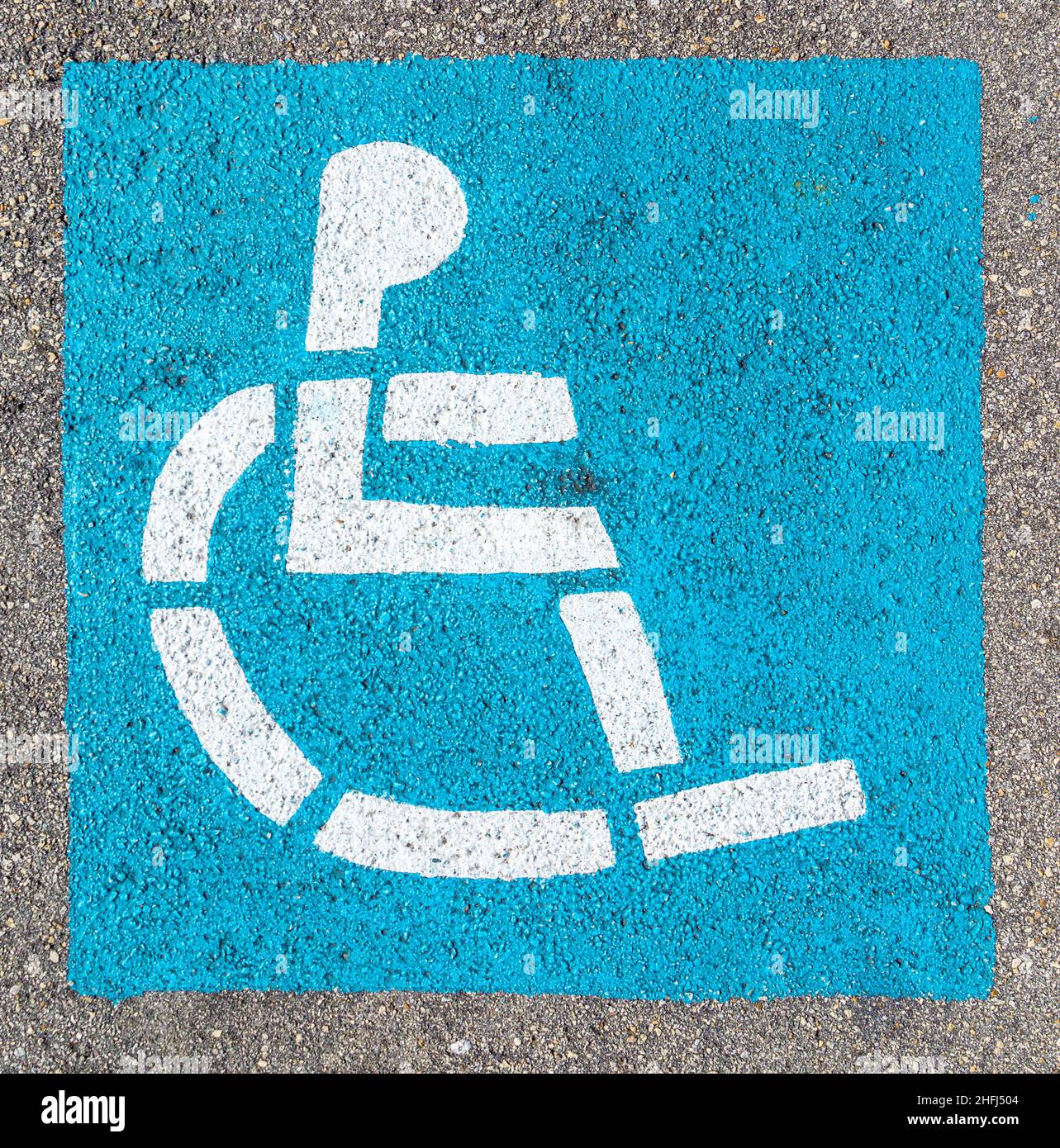 wheelchair sign at the parking lot in blue Stock Photo