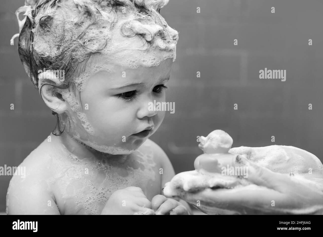 Hygiene and body care for children. Little baby child is washing her ...