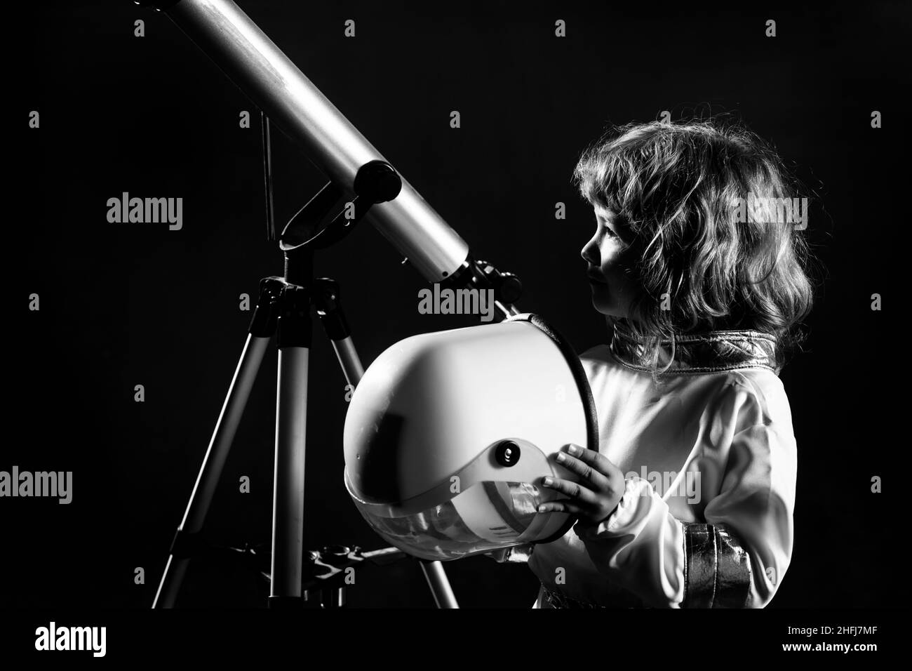 Boy playing to be an astronaut with space helmet and metal suit
