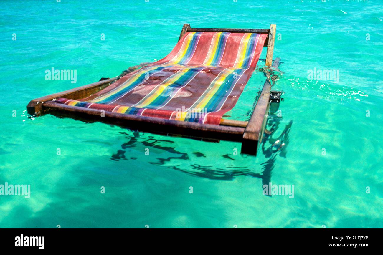 beach chair floating in the blue tropical clear sea Stock Photo