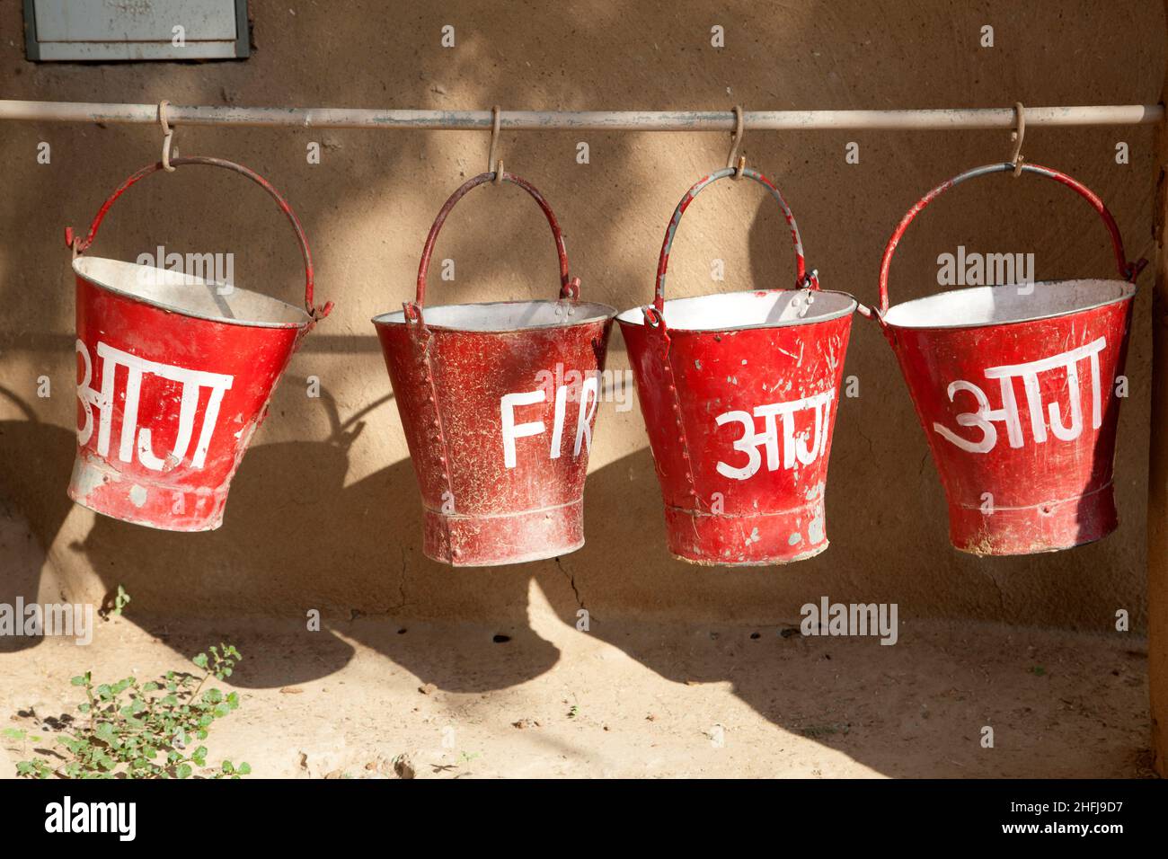 red fire buckets filled with sand to protect in case of fire Stock